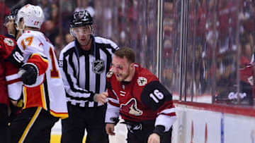 Dec 8, 2016; Glendale, AZ, USA; NHL linesman Brian Mach (78) escorts a bloody Arizona Coyotes left wing Max Domi (16) after a fight in the third period against the Calgary Flames at Gila River Arena. Mandatory Credit: Matt Kartozian-USA TODAY Sports