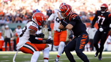 CINCINNATI, OH - NOVEMBER 07: Troy Hill #23 of the Cleveland Browns tackles Joe Burrow #9 of the Cincinnati Bengals during the game at Paul Brown Stadium on November 7, 2021 in Cincinnati, Ohio. (Photo by Kirk Irwin/Getty Images)