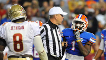 GAINESVILLE, FL - NOVEMBER 26: NCAA referee Matt Moore separates running back Chris Rainey #1 of the Florida Gators and defensive tackle Timmy Jerrigan #8 of the Florida State Seminoles November 26, 2011 at Ben Hill Griffin Stadium in Gainesville, Florida. (Photo by Al Messerschmidt/Getty Images)