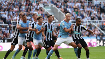 NEWCASTLE UPON TYNE, ENGLAND - AUGUST 21: Players holding back each other before a free kick during the Premier League match between Newcastle United and Manchester City at St. James Park on August 21, 2022 in Newcastle upon Tyne, United Kingdom. (Photo by Matthew Ashton - AMA/Getty Images)