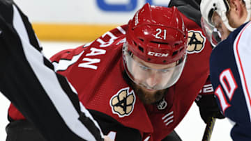 GLENDALE, ARIZONA - NOVEMBER 07: Derek Stepan #21 of the Arizona Coyotes gets ready to take a face-off against the Columbus Blue Jackets at Gila River Arena on November 07, 2019 in Glendale, Arizona. (Photo by Norm Hall/NHLI via Getty Images)