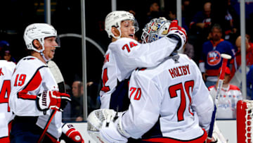 UNIONDALE, NEW YORK - MARCH 01: Nicklas Backstrom #19, John Carlson #74 and Braden Holtby #70 of the Washington Capitals celebrate their teams 3-1 win over the New York Islanders at NYCB Live's Nassau Coliseum on March 01, 2019 in Uniondale, New York. (Photo by Mike Stobe/NHLI via Getty Images)