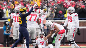 Michigan Wolverines linebacker David Ojabo (55) celebrates a sack of Ohio State Buckeyes quarterback C.J. Stroud (7) during the third quarter of the NCAA football game at Michigan Stadium in Ann Arbor on Saturday, Nov. 27, 2021.Ohio State Buckeyes At Michigan Wolverines