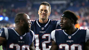 FOXBOROUGH, MA - OCTOBER 14: Tom Brady #12 of the New England Patriots celebrates with James White #28 and Kenjon Barner #38 of the New England Patriots after defeating the Kansas City Chiefs, 43-40, at Gillette Stadium on October 14, 2018 in Foxborough, Massachusetts. (Photo by Jim Rogash/Getty Images)