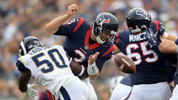 LOS ANGELES, CA - NOVEMBER 12: Samson Ebukam #50 of the Los Angeles Rams knocks the ball loose from Tom Savage #3 of the Houston Texans causing a fumble during the second half of game at Los Angeles Memorial Coliseum on November 12, 2017 in Los Angeles, California. (Photo by Sean M. Haffey/Getty Images)