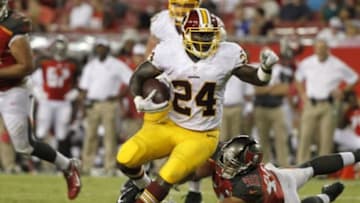 Aug 28, 2014; Tampa, FL, USA; Washington Redskins running back Silas Redd (24) runs with the ball as Tampa Bay Buccaneers middle linebacker Dane Fletcher (50) defends during the second half at Raymond James Stadium. The Redskins won 24-10. Mandatory Credit: Kim Klement-USA TODAY Sports