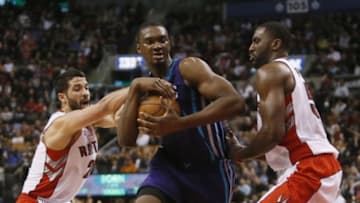 Apr 15, 2015; Toronto, Ontario, CAN; Charlotte Hornets forward Noah Vonleh (11) holds the ball as Toronto Raptors guard Greivis Vasquez (21) and Raptors forward Patrick Patterson (54) defend at the Air Canada Centre. The Hornets won 92-87. Mandatory Credit: John E. Sokolowski-USA TODAY Sports