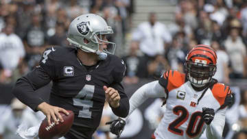 September 13, 2015; Oakland, CA, USA; Oakland Raiders quarterback Derek Carr (4) is pressured by Cincinnati Bengals free safety Reggie Nelson (20) during the first quarter at O.co Coliseum. Mandatory Credit: Kyle Terada-USA TODAY Sports