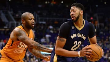 Dec 11, 2016; Phoenix, AZ, USA; New Orleans Pelicans forward Anthony Davis (23) handles the ball against Phoenix Suns forward P.J. Tucker (17) in the first half at Talking Stick Resort Arena. Mandatory Credit: Jennifer Stewart-USA TODAY Sports