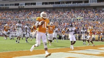 Jan 1, 2016; Tampa, FL, USA; Tennessee Volunteers quarterback Joshua Dobbs (11) runs the ball for a touchdown against the Northwestern Wildcats in the first quarter at the 2016 Outback Bowl at Raymond James Stadium. Mandatory Credit: Mark Zerof-USA TODAY Sports