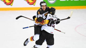 Germany's defender Leon Gawanke (L) celebrates scoring the 2-2 equaliser with Germany's forward Matthias Plachta during the IIHF Men's Ice Hockey World Championships quarter final match between Switzerland and Germany, at the Olympic Sports Center in Riga, Latvia, on June 3, 2021. (Photo by Gints IVUSKANS / AFP) (Photo by GINTS IVUSKANS/AFP via Getty Images)