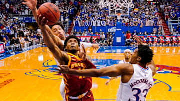 Jan 11, 2022; Lawrence, Kansas, USA; Iowa State Cyclones guard Tyrese Hunter (11) shoots as Kansas Jayhawks forward Jalen Wilson (10) and forward David McCormack (33) defend during the second half at Allen Fieldhouse. Mandatory Credit: Jay Biggerstaff-USA TODAY Sports
