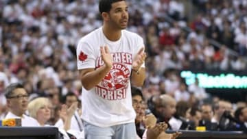 Apr 19, 2014; Toronto, Ontario, CAN; Actor and rap artist Drake cheers on his team during the Toronto Raptors game against the Brooklyn Nets in game one during the first round of the 2014 NBA Playoffs at Air Canada Centre. The Nets beat the Raptors 94-87. Mandatory Credit: Tom Szczerbowski-USA TODAY Sports