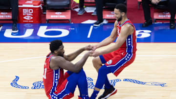 May 14, 2021; Philadelphia, Pennsylvania, USA; Philadelphia 76ers guard Ben Simmons (25) helps center Joel Embiid (21) up from the court floor during the second quarter against the Orlando Magic at Wells Fargo Center. Mandatory Credit: Bill Streicher-USA TODAY Sports