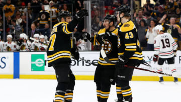 BOSTON, MASSACHUSETTS - FEBRUARY 12: Danton Heinen #43 of the Boston Bruins celebrates with Brad Marchand #63 and Patrice Bergeron #37 after scoring a goal against the Chicago Blackhawks during the first period at TD Garden on February 12, 2019 in Boston, Massachusetts. (Photo by Maddie Meyer/Getty Images)