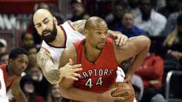 Feb 20, 2015; Atlanta, GA, USA; Toronto Raptors center Chuck Hayes (44) is defended by Atlanta Hawks forward Pero Antic (6) during the second half at Philips Arena. The Raptors defeated the Hawks 105-80. Mandatory Credit: Dale Zanine-USA TODAY Sports