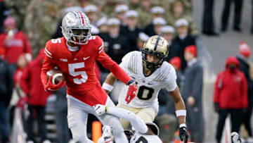 Ohio State Buckeyes wide receiver Garrett Wilson (5) is snagged by Purdue Boilermakers safety Chris Jefferson (17) during the first quarter of Saturday's NCAA Division I football game at Ohio Stadium in Columbus, Oh., on November 13, 2021.Osu21pur Bjp 319