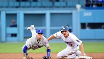 LOS ANGELES, CA - OCTOBER 19: Javier Baez #9 of the Chicago Cubs throws the ball to first base as Corey Seager #5 of the Los Angeles Dodgers is out at second base in the first inning in game four of the National League Championship Series at Dodger Stadium on October 19, 2016 in Los Angeles, California. (Photo by Harry How/Getty Images)
