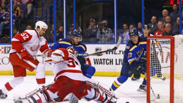 Oct 27, 2016; St. Louis, MO, USA; St. Louis Blues left wing David Perron (57) shoots the puck past the outstretched Detroit Red Wings goalie Petr Mrazek (34) during the second period at Scottrade Center. Mandatory Credit: Billy Hurst-USA TODAY Sports