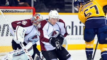 Jan 27, 2015; Nashville, TN, USA; Colorado Avalanche defenseman Tyson Barrie (4) falls to the ice to block a shot by Nashville Predators left winger Gabriel Bourque (57) during the first period at Bridgestone Arena. Mandatory Credit: Christopher Hanewinckel-USA TODAY Sports