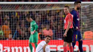 BARCELONA, SPAIN - MAY 06: Cristiano Ronaldo of Real Madrid (R) is injured as he scores his sides first goal during the La Liga match between Barcelona and Real Madrid at Camp Nou on May 6, 2018 in Barcelona, Spain. (Photo by Alex Caparros/Getty Images)
