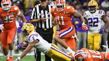 NEW ORLEANS, LA - JANUARY 13: Justin Jefferson #2 of the LSU Tigers is tackled by K'Von Wallace #12 of the Clemson Tigers during the College Football Playoff National Championship held at the Mercedes-Benz Superdome on January 13, 2020 in New Orleans, Louisiana. (Photo by Justin Tafoya/Getty Images)