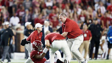 TUSCALOOSA, AL - OCTOBER 13: Tua Tagovailoa #13 of the Alabama Crimson Tide is looked at after suffering an injury in the third quarter of the game against the Missouri Tigers at Bryant-Denny Stadium on October 13, 2018 in Tuscaloosa, Alabama. Tagovailoa did not return to the game. Alabama won 39-10. (Photo by Joe Robbins/Getty Images)