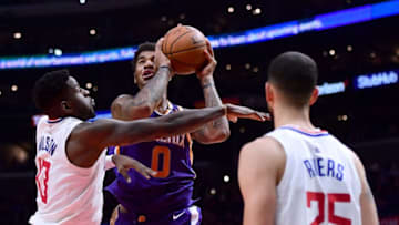 LOS ANGELES, CA - DECEMBER 20: Marquese Chriss #0 of the Phoenix Suns attempts a shot between the defense of Jamil Wilson #13 and Austin Rivers #25 during a 108-95 Clipper win at Staples Center on December 20, 2017 in Los Angeles, California. (Photo by Harry How/Getty Images)