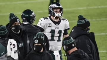 Dec 6, 2020; Green Bay, Wisconsin, USA; Philadelphia Eagles quarterback Carson Wentz (11) watches the game from the sidelines in the third quarter during the game against the Green Bay Packers at Lambeau Field. Mandatory Credit: Benny Sieu-USA TODAY Sports