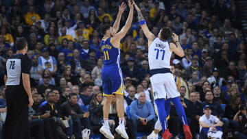 OAKLAND, CA - DECEMBER 22: Klay Thompson #11 of the Golden State Warriors shoots over Luka Doncic #77 of the Dallas Mavericks during an NBA basketball game at ORACLE Arena on December 22, 2018 in Oakland, California. NOTE TO USER: User expressly acknowledges and agrees that, by downloading and or using this photograph, User is consenting to the terms and conditions of the Getty Images License Agreement. (Photo by Thearon W. Henderson/Getty Images)