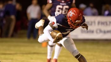 Vanguard Fred Gaskin (4) takes a flying leap over Carol City defenders as Carol City travels to take on Vanguard Championships Friday, Oct. 28, 2022, at Booster Stadium in Ocala, Fla. [Alan Youngblood/Special to the Ocala Star-Banner]Oca Carolcity Vs Vhs Fb