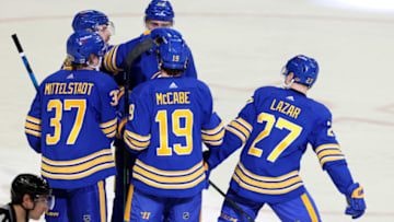 Jan 31, 2021; Buffalo, New York, USA; Buffalo Sabres center Curtis Lazar (27) celebrates his goal with teammates during the second period against the New Jersey Devils at KeyBank Center. Mandatory Credit: Timothy T. Ludwig-USA TODAY Sports