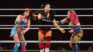 SINGAPORE - JUNE 27: Kairi Sane (L) and Asuka (R) compete against Billie Kay of The IIconics during the WWE Live Singapore at the Singapore Indoor Stadium on June 27, 2019 in Singapore. (Photo by Suhaimi Abdullah/Getty Images for Singapore Sports Hub)