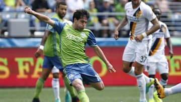 Jul 31, 2016; Seattle, WA, USA; Seattle Sounders midfielder Nicolas Lodeiro (10) shoots against the Los Angeles Galaxy during the first half at CenturyLink Field. Seattle tied Los Angeles, 1-1. Mandatory Credit: Joe Nicholson-USA TODAY Sports