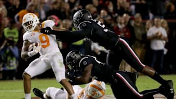 COLUMBIA, SC - OCTOBER 27: Teammates Kingsley Enagbare #52 and Sherrod Greene #44 of the South Carolina Gamecocks try to stop Tim Jordan #9 of the Tennessee Volunteers during their game at Williams-Brice Stadium on October 27, 2018 in Columbia, South Carolina. (Photo by Streeter Lecka/Getty Images)