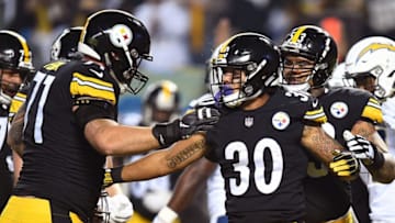 PITTSBURGH, PA - DECEMBER 02: James Conner #30 of the Pittsburgh Steelers celebrates with Matt Feiler #71 after a 1 yard rushing touchdown in the first quarter during the game against the Los Angeles Chargers at Heinz Field on December 2, 2018 in Pittsburgh, Pennsylvania. (Photo by Joe Sargent/Getty Images)