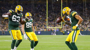 Sep 28, 2023; Green Bay, Wisconsin, USA; Green Bay Packers wide receiver Christian Watson (9) celebrates with offensive tackle Rasheed Walker (63) and tight end Ben Sims (89) after scoring a touchdown against the Detroit Lions during their football game on Thursday, September 28, 2023, at Lambeau Field in Green Bay, Wis. The Lions won the game, 34-20. Mandatory Credit: Tork Mason-USA TODAY Sports