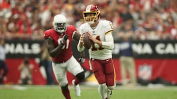 GLENDALE, AZ - SEPTEMBER 09: Quarterback Alex Smith #11 of the Washington Redskins looks to pass ahead of defensive end Benson Mayowa #91 of the Arizona Cardinals during the NFL game at State Farm Stadium on September 9, 2018 in Glendale, Arizona. (Photo by Christian Petersen/Getty Images)