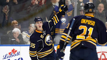 Dec 16, 2016; Buffalo, NY, USA; Buffalo Sabres defenseman Rasmus Ristolainen (55) celebrates after scoring the winning goal in overtime against the New York Islanders as right wing Kyle Okposo (21) looks on at KeyBank Center. Sabres beat the Islanders 3-2 in overtime. Mandatory Credit: Kevin Hoffman-USA TODAY Sports