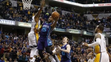 Feb 26, 2016; Indianapolis, IN, USA; Charlotte Hornets guard Kemba Walker (15) shoots the ball around Indiana Pacers forward Paul George (13) at Bankers Life Fieldhouse. The Hornets won 96-95. Mandatory Credit: Brian Spurlock-USA TODAY Sports