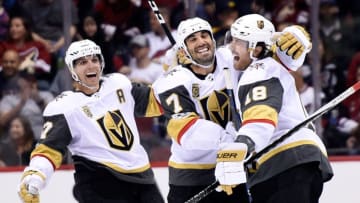 GLENDALE, AZ - OCTOBER 07: David Perron #57, Jason Garrison #7 and James Neal #18 of the Vegas Golden Knights celebrate the game-winning goal against the Arizona Coyotes at Gila River Arena on October 7, 2017 in Glendale, Arizona. Vegas won 2-1 in overtime. (Photo by David Becker/NHLI via Getty Images)