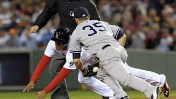 Sep 15, 2013; Boston, MA, USA; Boston Red Sox third baseman Xander Bogaerts (rear) slides past the tag of New York Yankees shortstop Brendan Ryan (35) during the fourth inning at Fenway Park. Mandatory Credit: Bob DeChiara-USA TODAY Sports