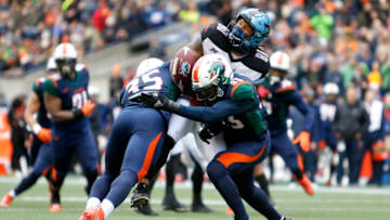 SEATTLE, WA - FEBRUARY 22: Sean Price #80 of the Dallas Renegades loses the football after being hit by Godwin Igwebuike #35 of the Seattle Dragons and Jordan Martin #33 during the XFL game at CenturyLink Field on February 22, 2020 in Seattle, Washington. (Photo by Jenny Buchanan/XFL via Getty Images)