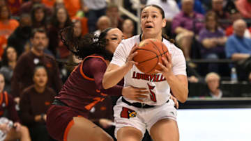 Mar 5, 2023; Greensboro, NC, USA; Louisville Cardinals guard Mykasa Robinson (5) is grabbed by Virginia Tech Hokies guard Kayana Traylor (23) on a shot during the first half at Greensboro Coliseum. Mandatory Credit: William Howard-USA TODAY Sports