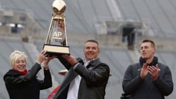 Jan 24, 2015; Columbus, OH, USA; Ohio State Buckeyes head coach Urban Meyer (right) with Associated Press Trophy during the national championship celebration at Ohio Stadium. Mandatory Credit: Joe Maiorana-USA TODAY Sports