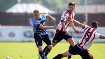 SUNDERLAND, ENGLAND - AUGUST 23: Alex Pritchard of Spurs looses his footing under pressure from Liam Agnew and Valentin Roberge of Sunderland during the Barclays U21 Premier League match between Sunderland U21 and Tottenham Hotspur U21 at Eppleton Colliery Welfare ground on August 23, 2015 in Sunderland, England. (Photo by Jan Kruger/Getty Images)