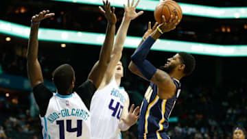 Nov 7, 2016; Charlotte, NC, USA; Indiana Pacers forward Paul George (13) shoots the ball over Charlotte Hornets forward Cody Zeller (40) and forward Michael Kidd-Gilchrist (14) in the first half at Spectrum Center. Mandatory Credit: Jeremy Brevard-USA TODAY Sports