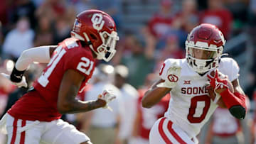 OU's Eric Gray (0) runs past Kendall Dennis (21) during the Sooners' spring football game on April 24.ONLY cut out of eric gray (0)