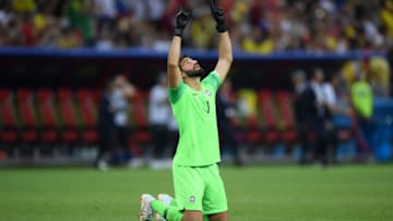 KAZAN, RUSSIA - JULY 06: Alisson of Brazil prays following his sides defeat in the 2018 FIFA World Cup Russia Quarter Final match between Brazil and Belgium at Kazan Arena on July 6, 2018 in Kazan, Russia. (Photo by Shaun Botterill/Getty Images)