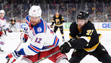 Nov 26, 2021; Boston, Massachusetts, USA; New York Rangers defenseman Patrik Nemeth (12) and Boston Bruins left wing Taylor Hall (71) battle for the puck during the third period at TD Garden. Mandatory Credit: Bob DeChiara-USA TODAY Sports